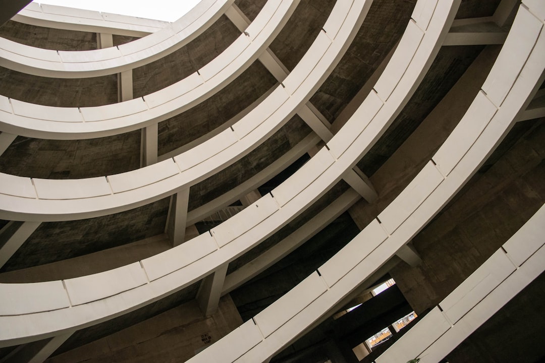 white concrete spiral staircase with white wooden railings,