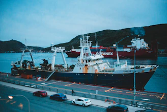 Wide shot of oceapure team preparing equipment on a dock with a large commercial vessel in the background.
