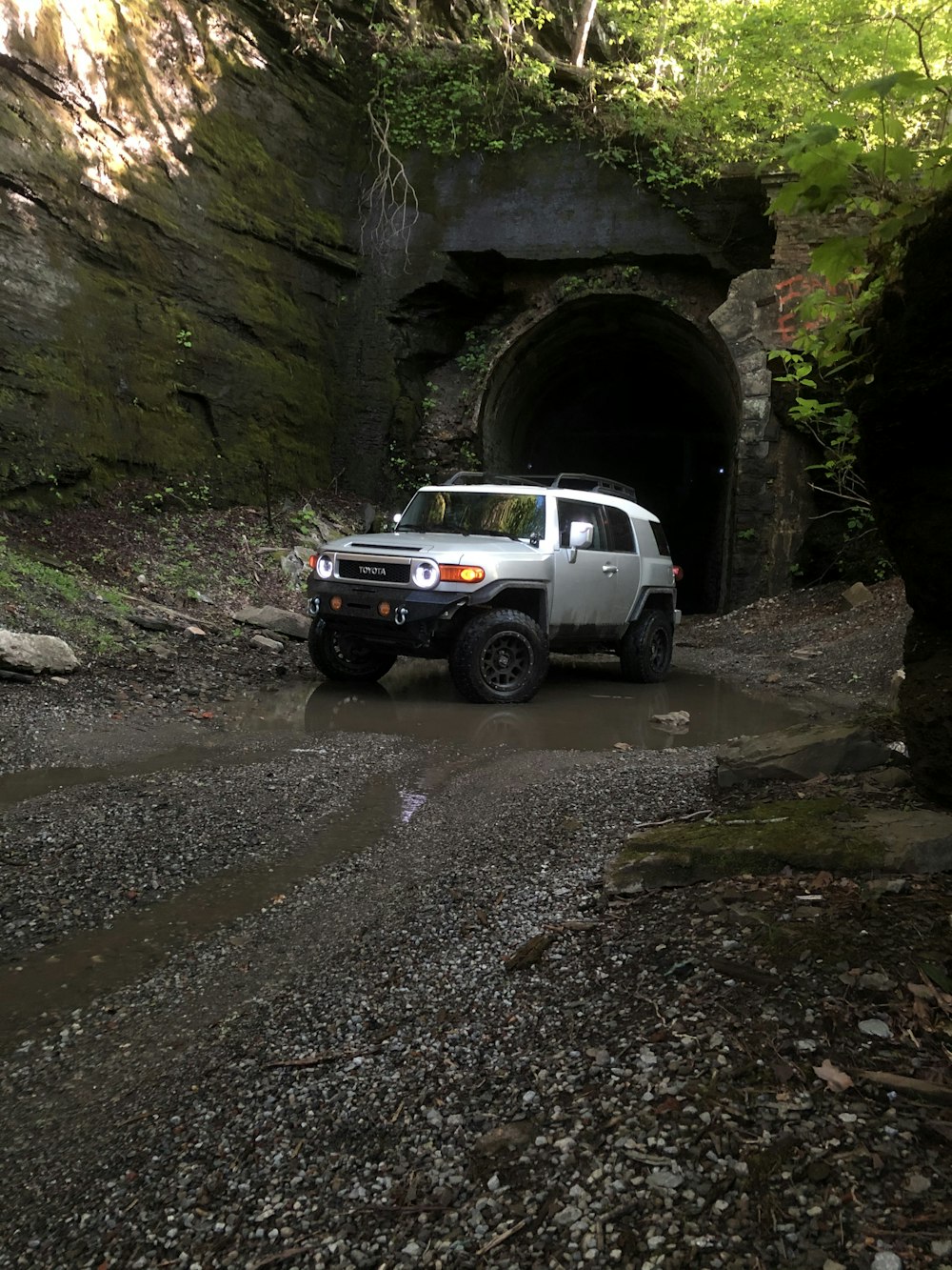 white suv parked near gray rock formation during daytime