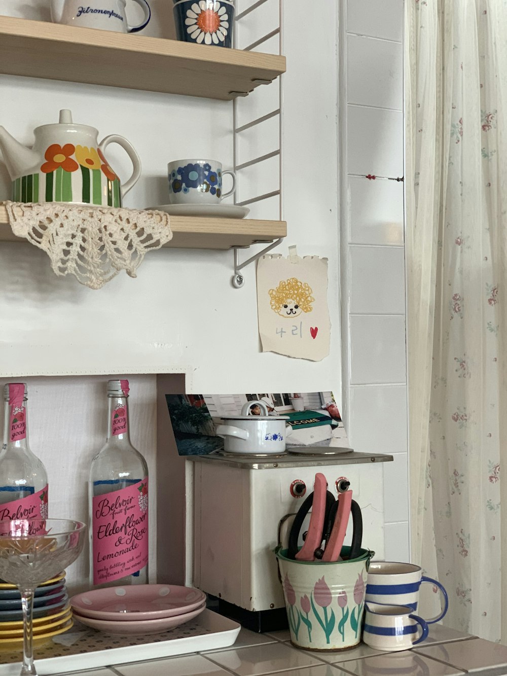 clear plastic bottle on white wooden shelf