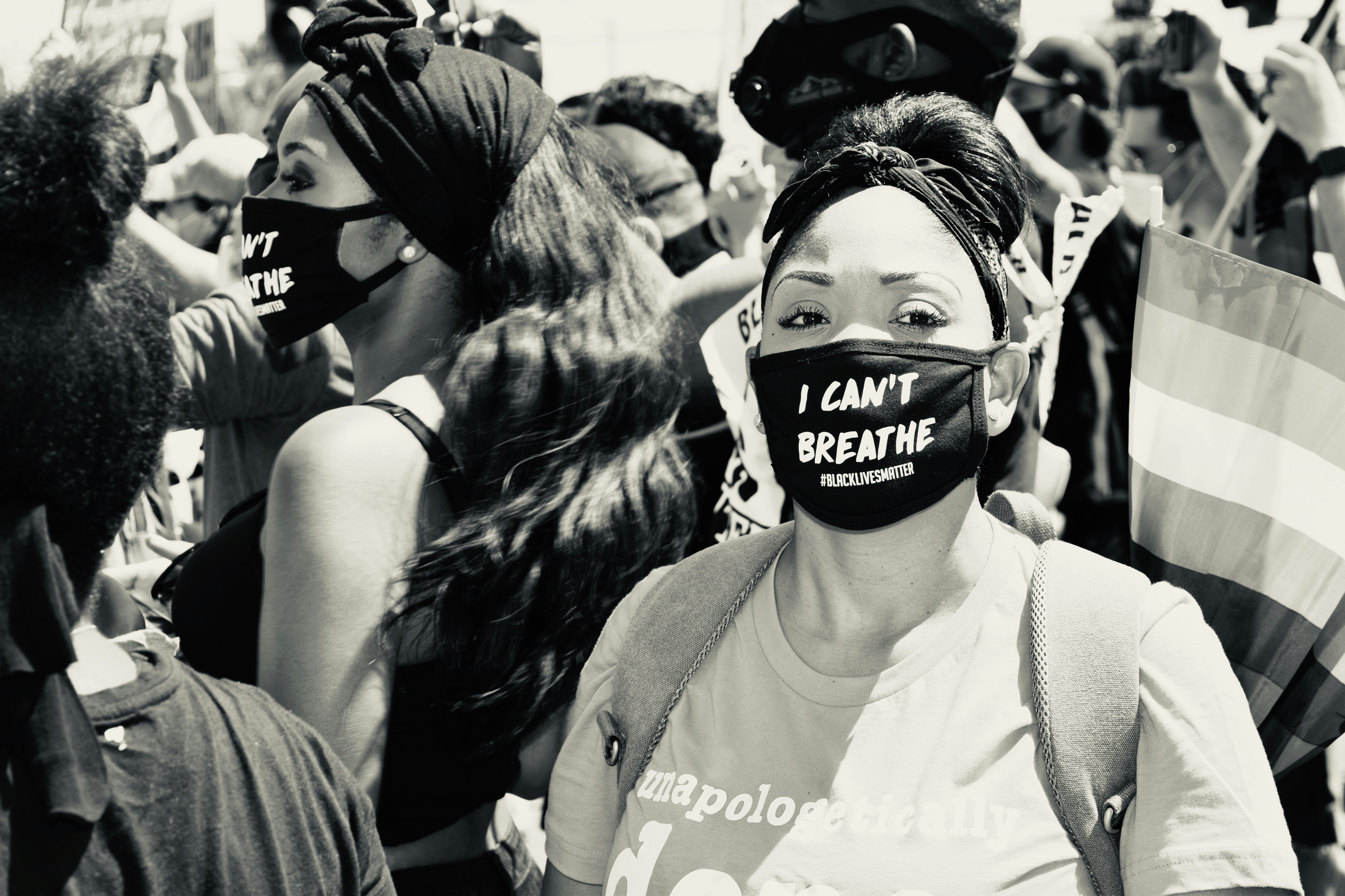 woman in white tank top wearing black mask