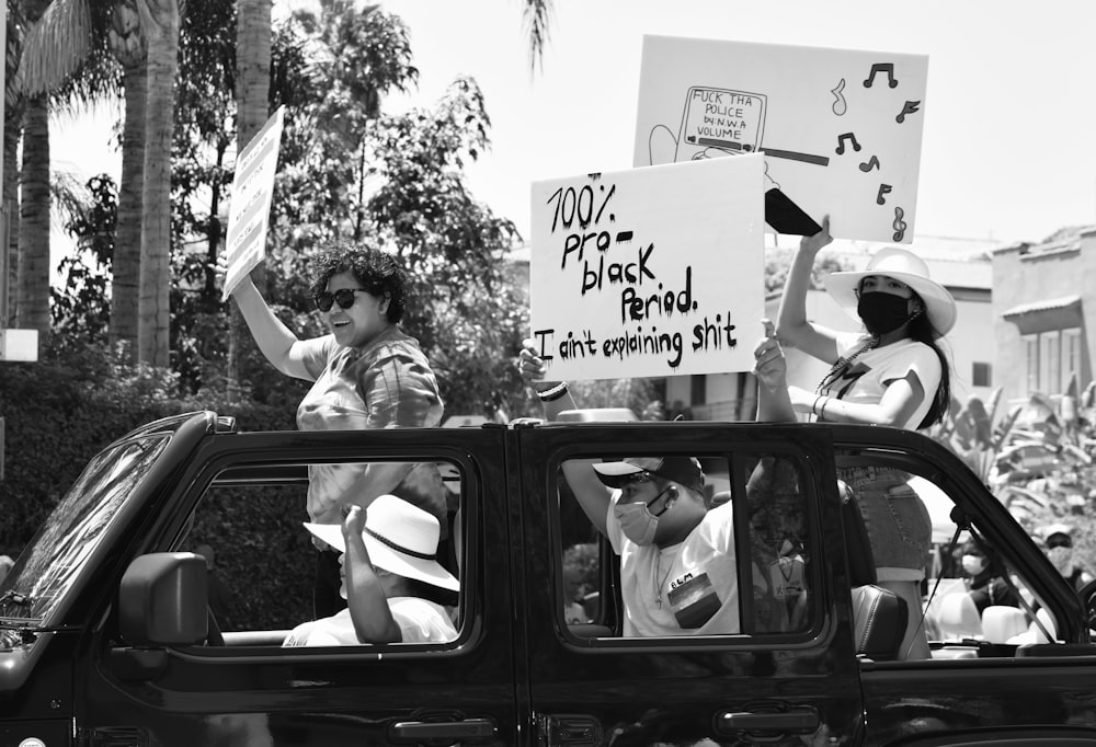 grayscale photo of man and woman in car