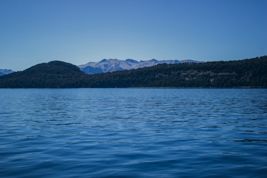 blue sea near mountain under blue sky during daytime in San Carlos de Bariloche Argentina