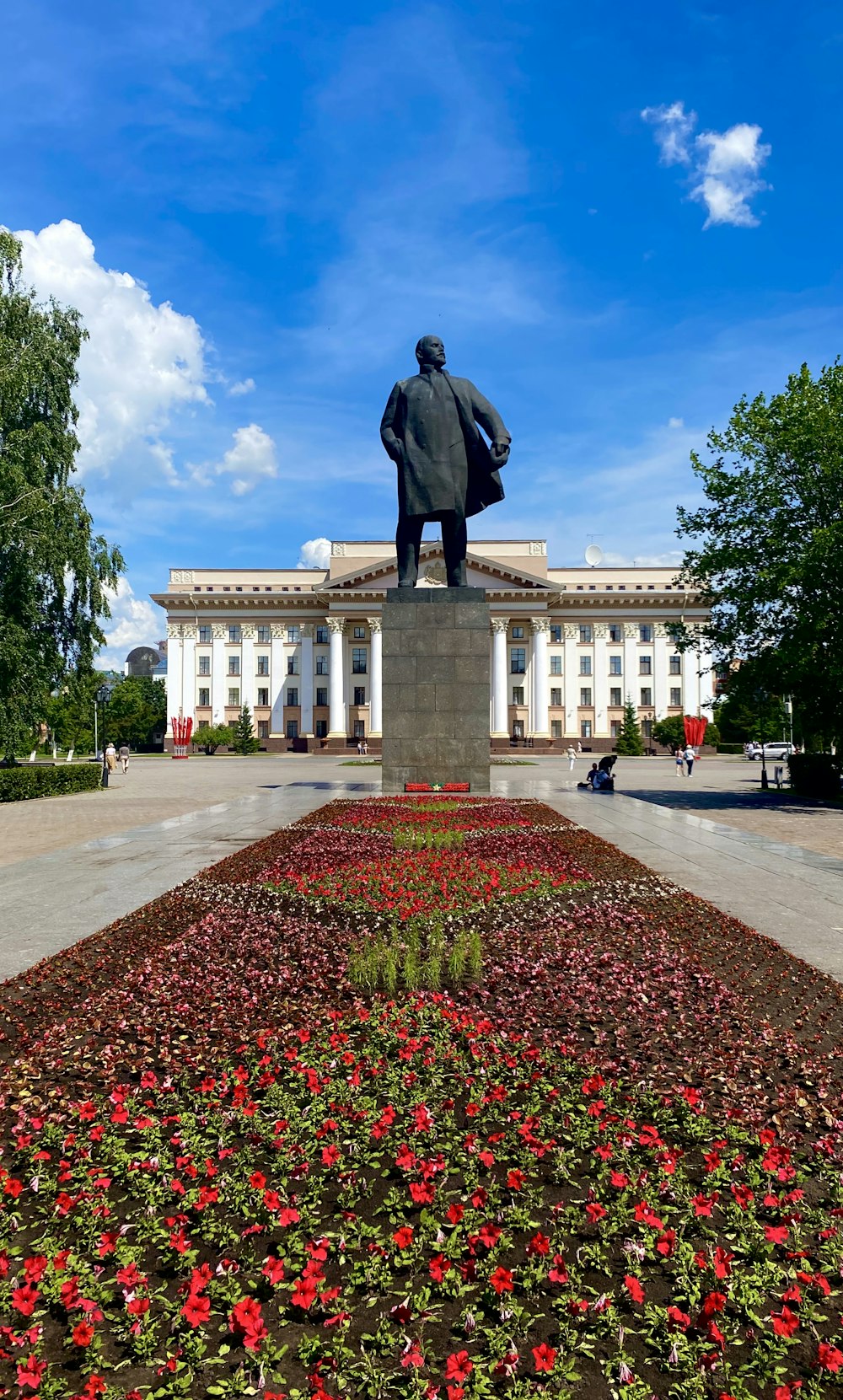 man statue in front of white building