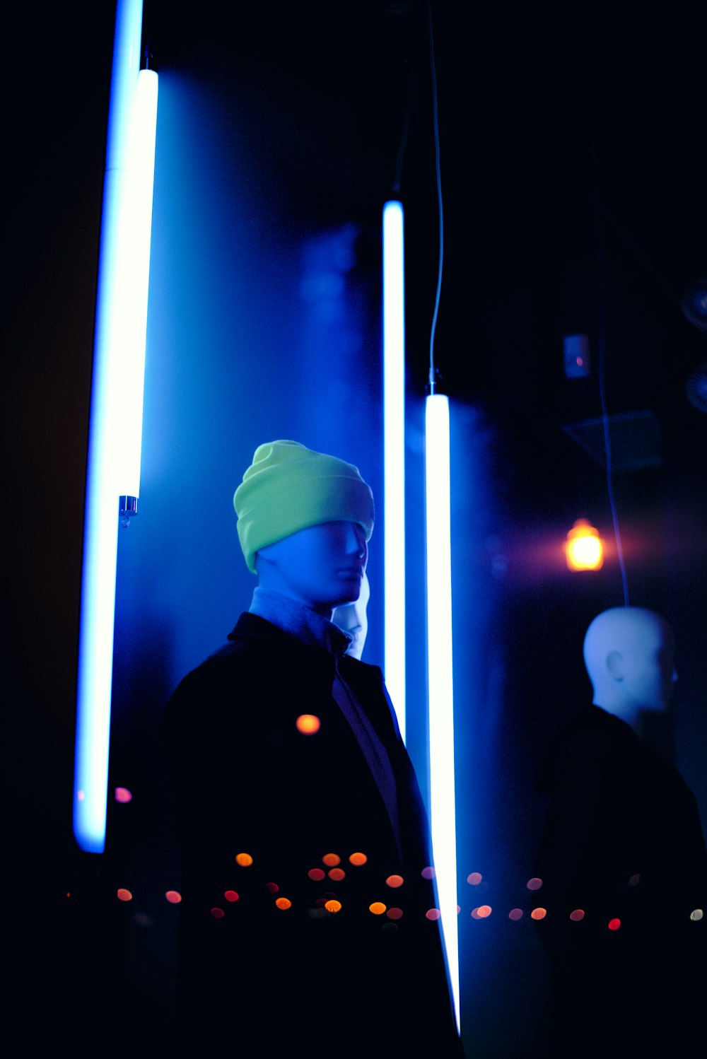 man in black uniform standing near white light