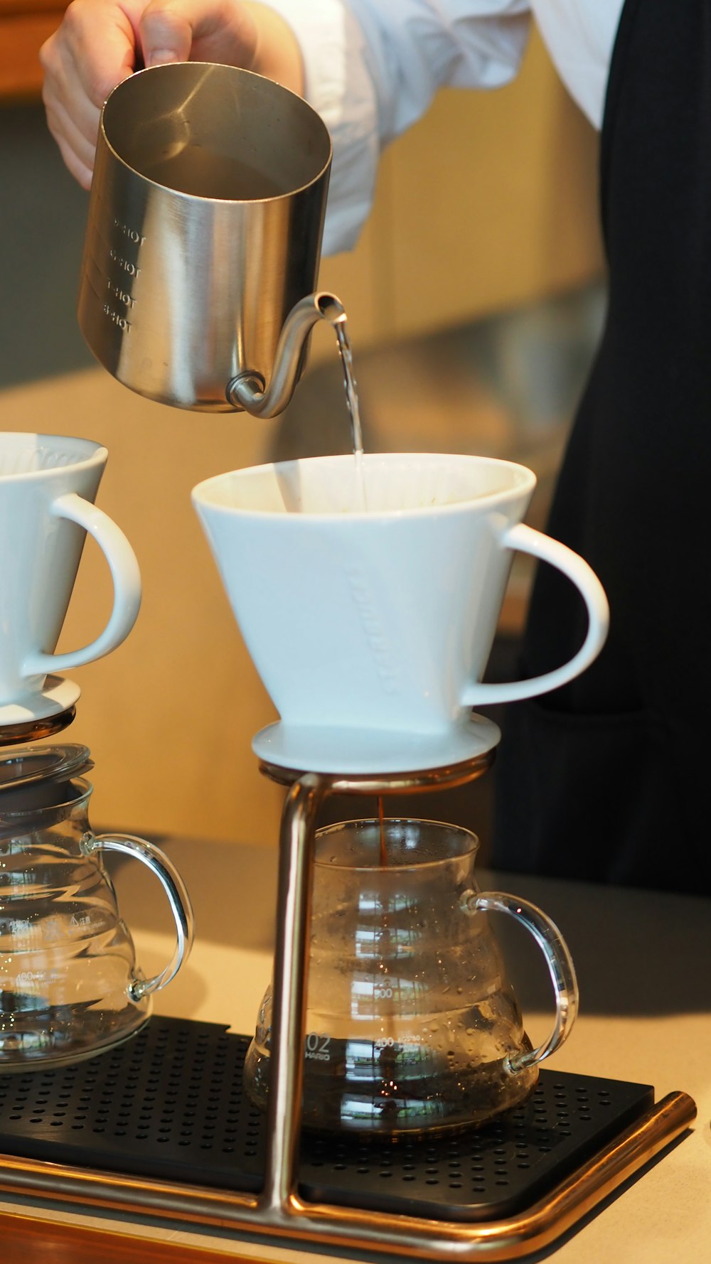 white ceramic mug on clear glass coffee maker