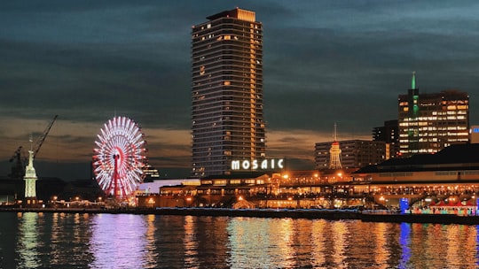 city skyline across body of water during night time in Kobe Port Tower Japan