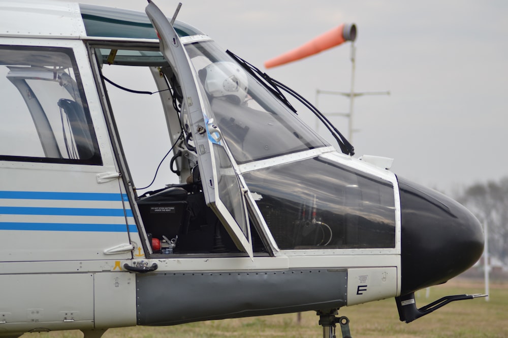 gray and blue airplane on field during daytime