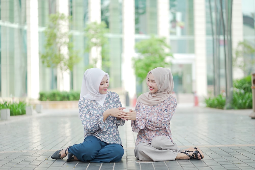 2 women sitting on the floor