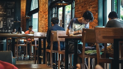 A cozy coffee shop setting with students discussing ideas.