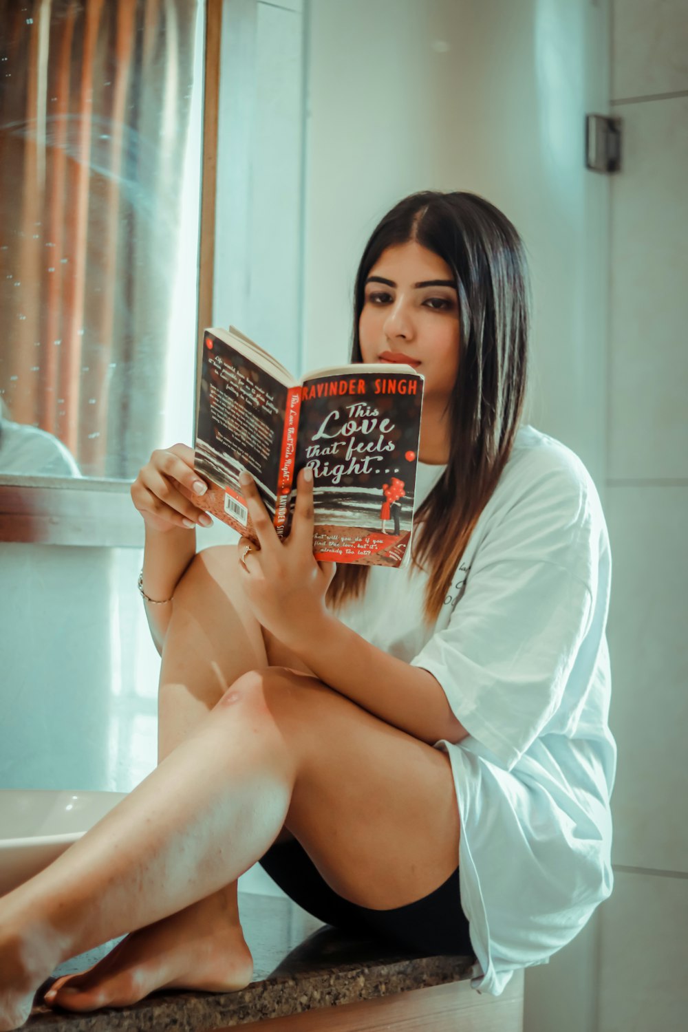 woman in white shirt reading book
