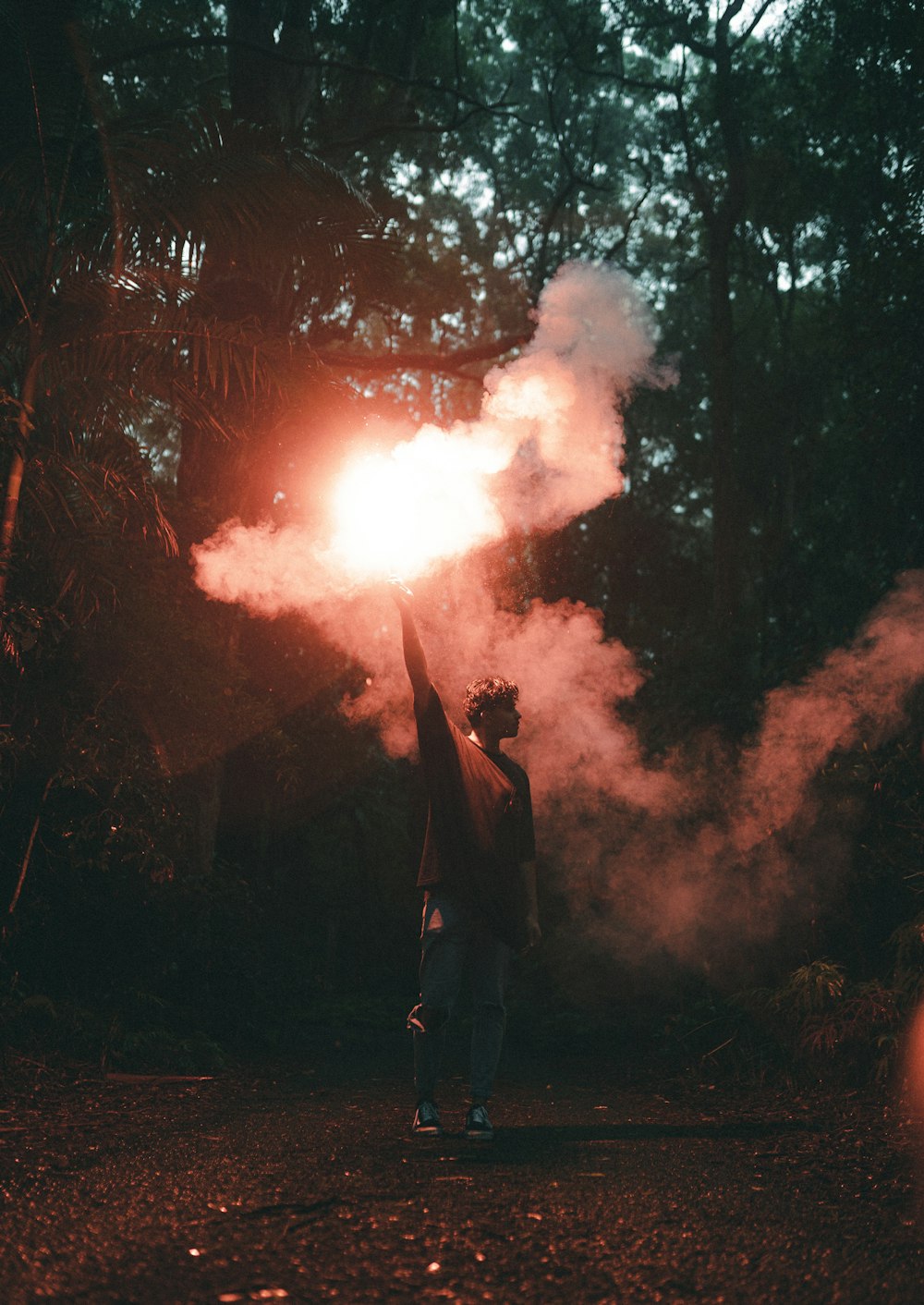 man in black jacket standing near fire