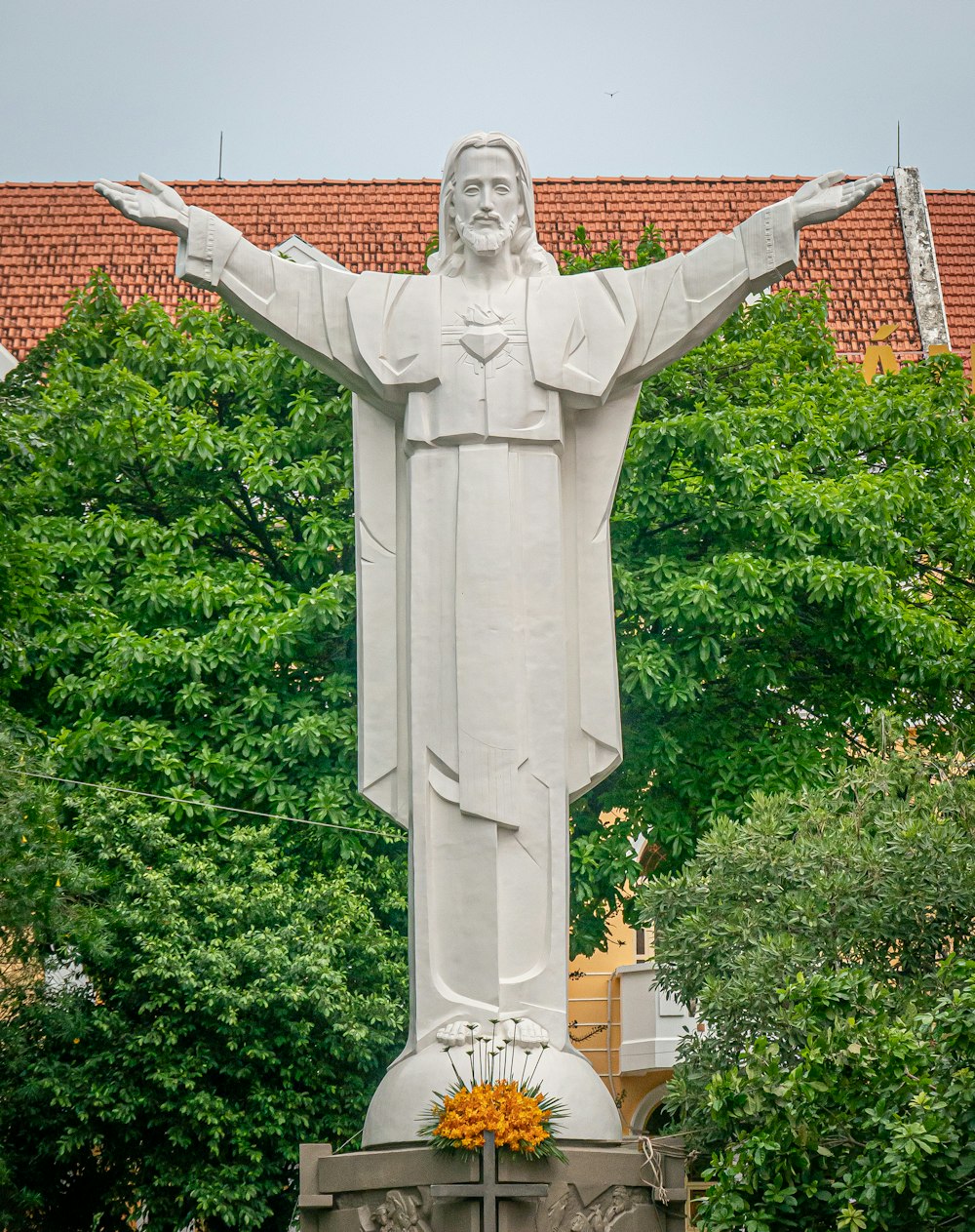 white statue of man holding book