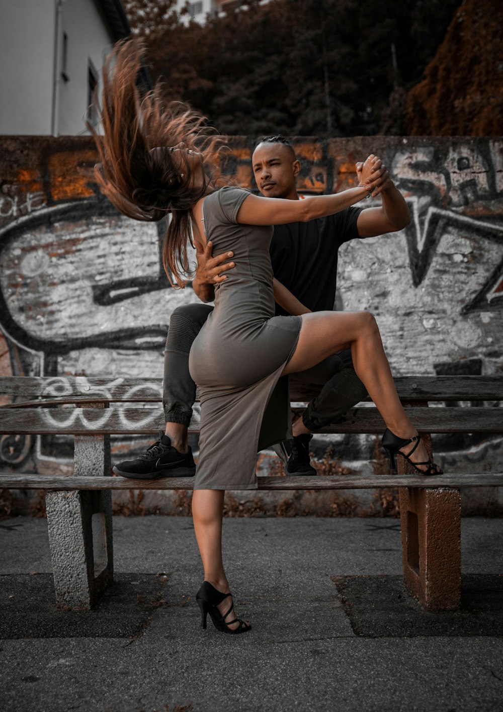 woman in black tank top and black leggings sitting on brown wooden bench