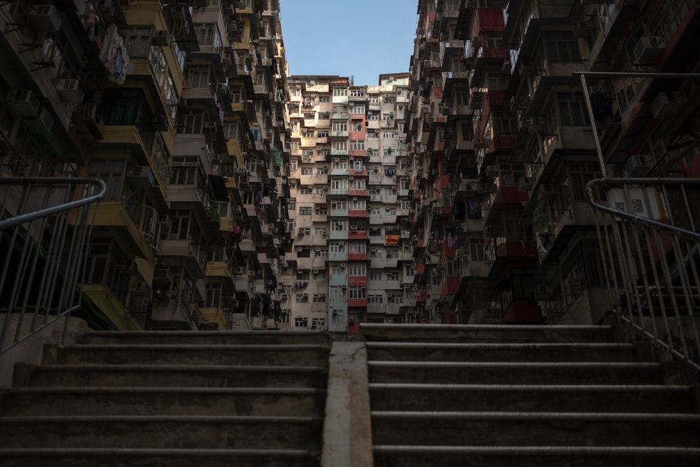 gray concrete stairs between concrete buildings during daytime