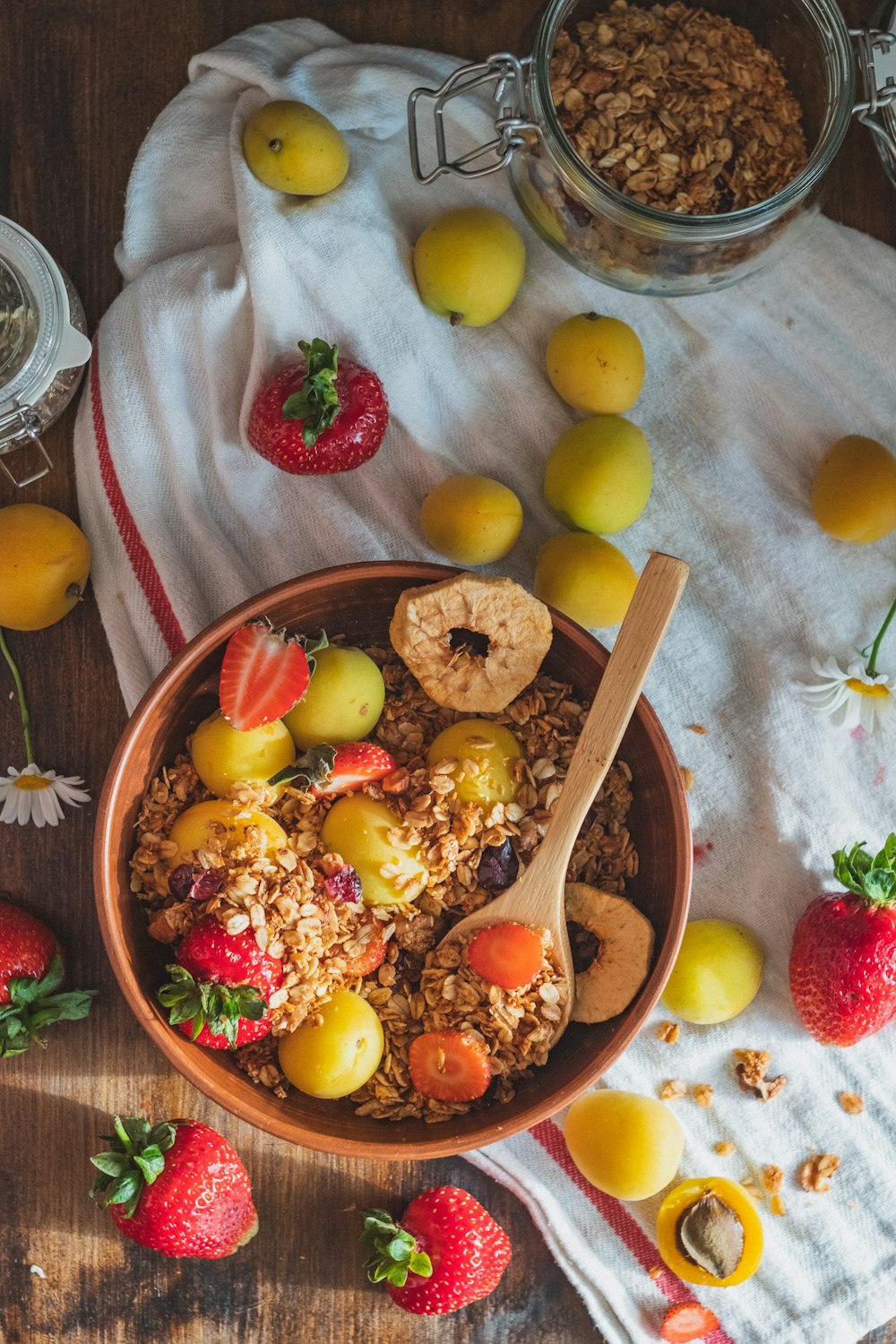 brown wooden spoon with sliced fruits on brown wooden bowl