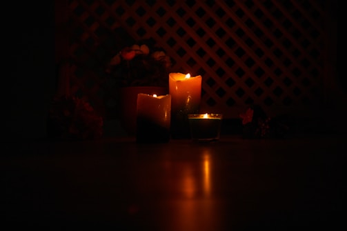 lighted candles on brown wooden table