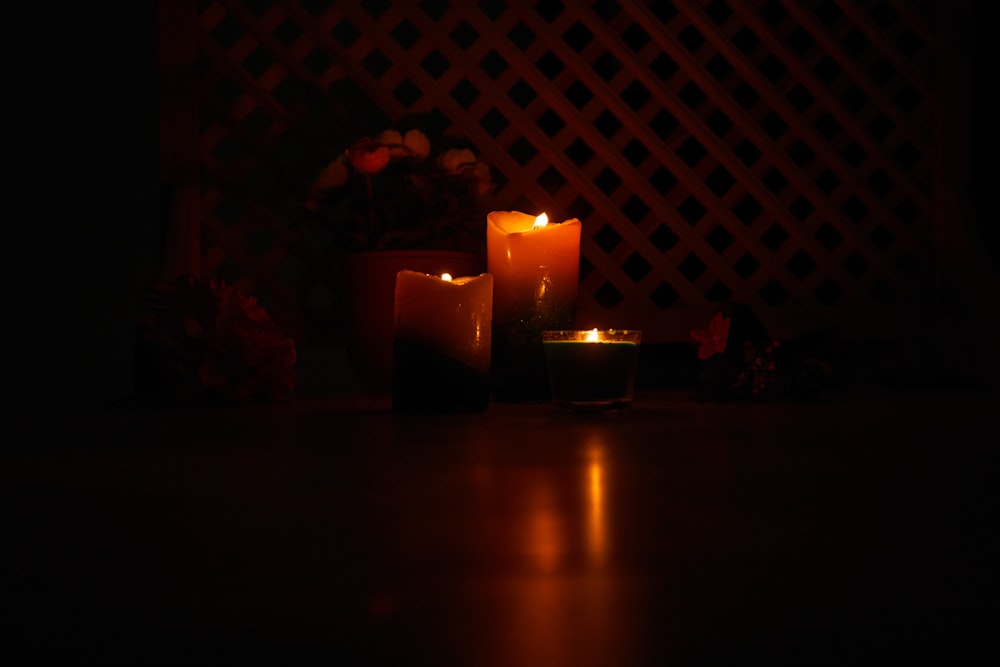 lighted candles on brown wooden table