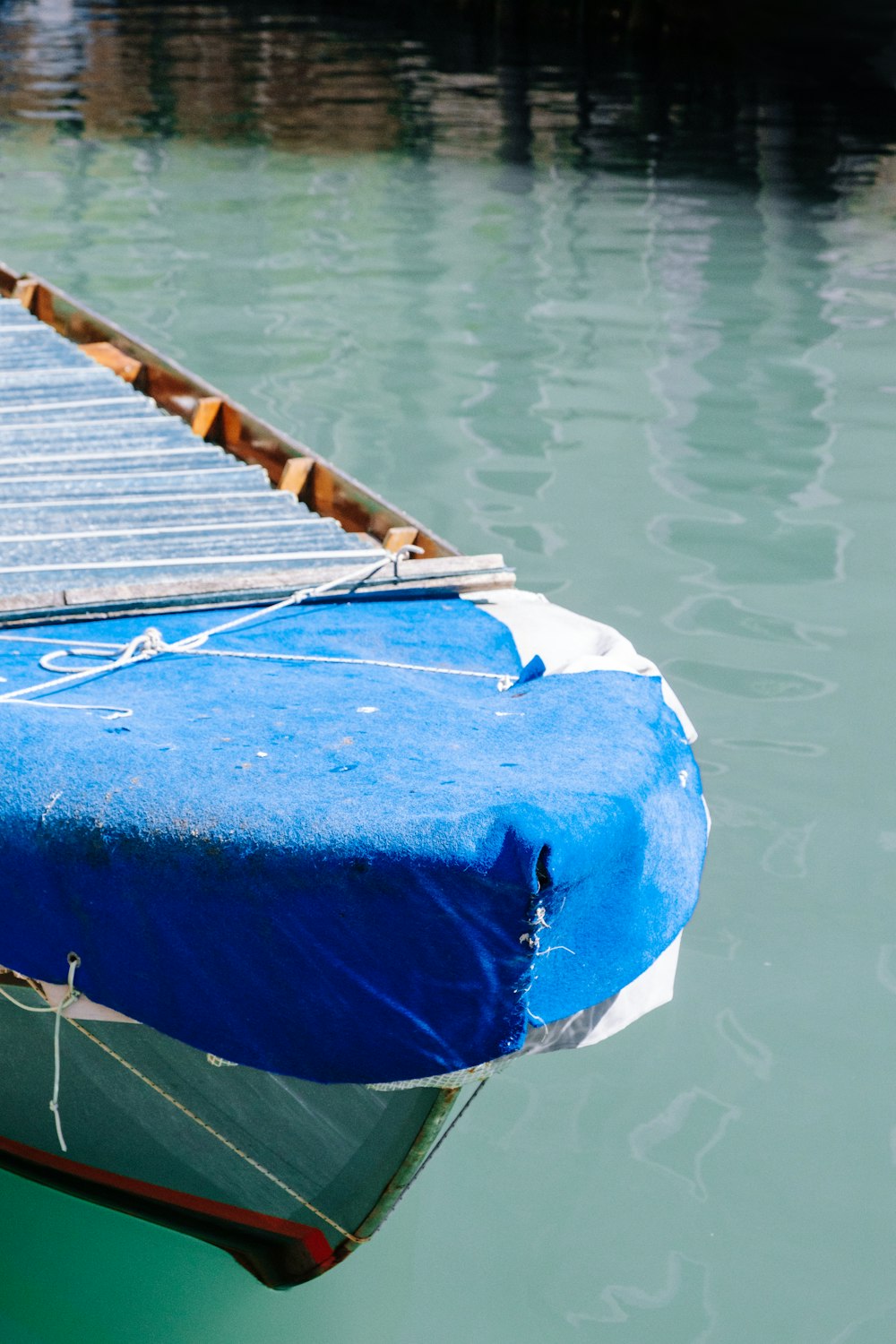 blue textile on brown wooden dock