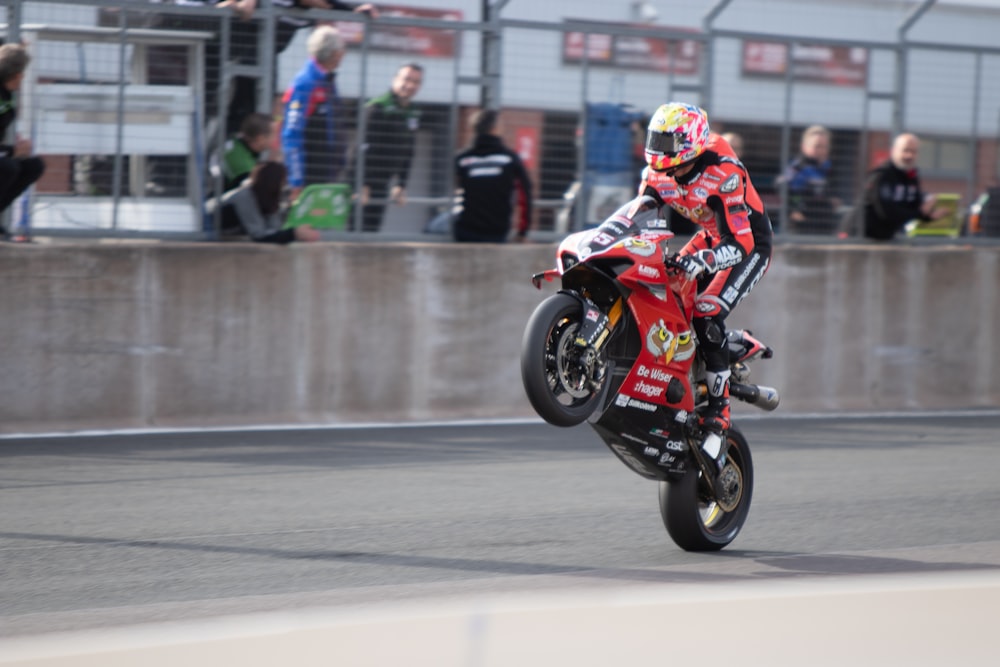 man in red and black motorcycle suit riding on motorcycle