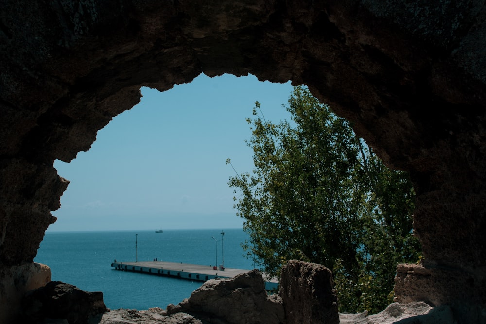 brown rock formation near body of water during daytime