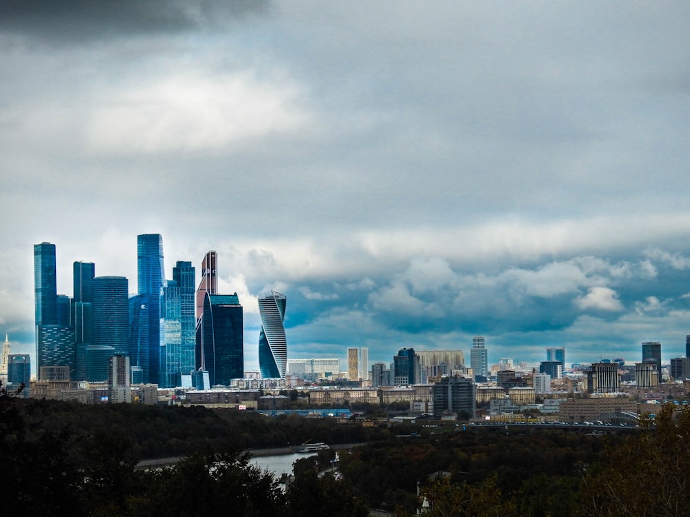 city skyline under white clouds during daytime