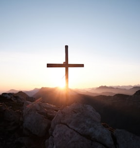 brown cross on brown rock during daytime