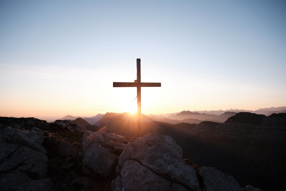 brown cross on brown rock during daytime