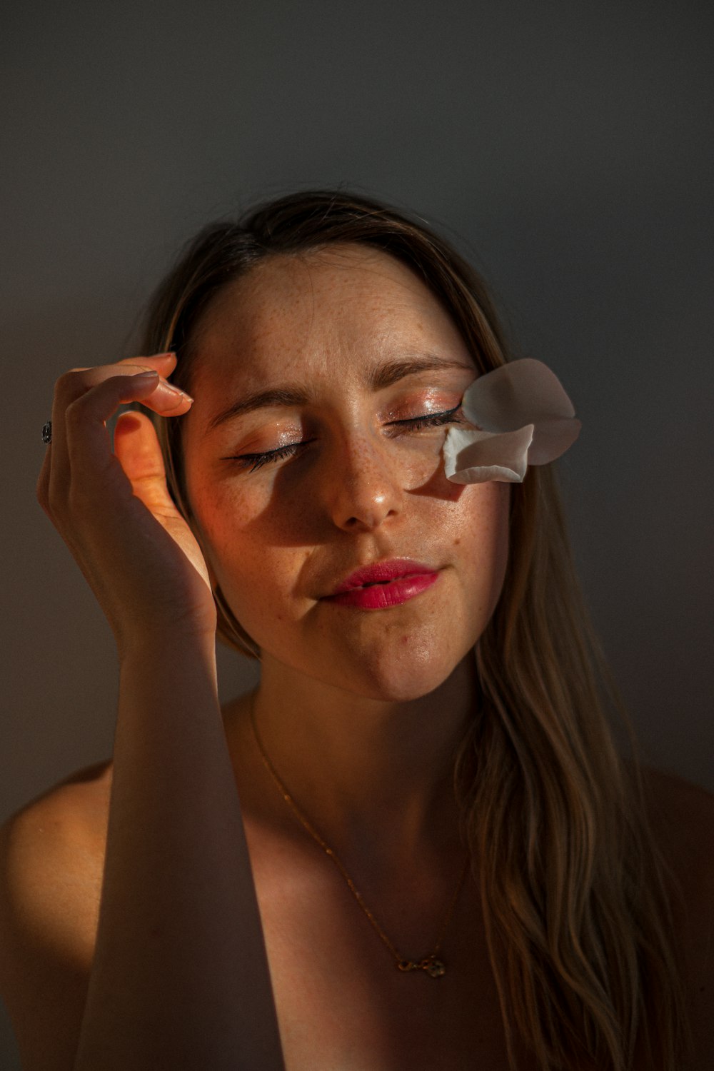 woman with white flower on her face