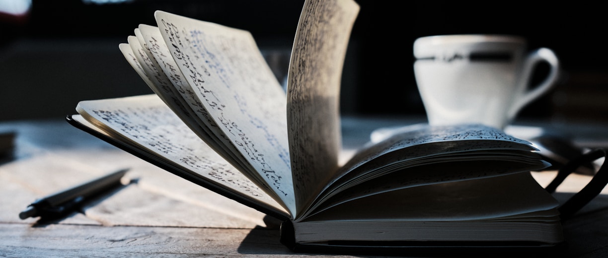 open book on brown wooden table