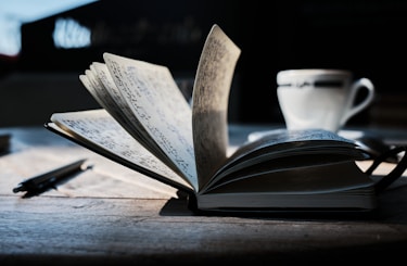 open book on brown wooden table