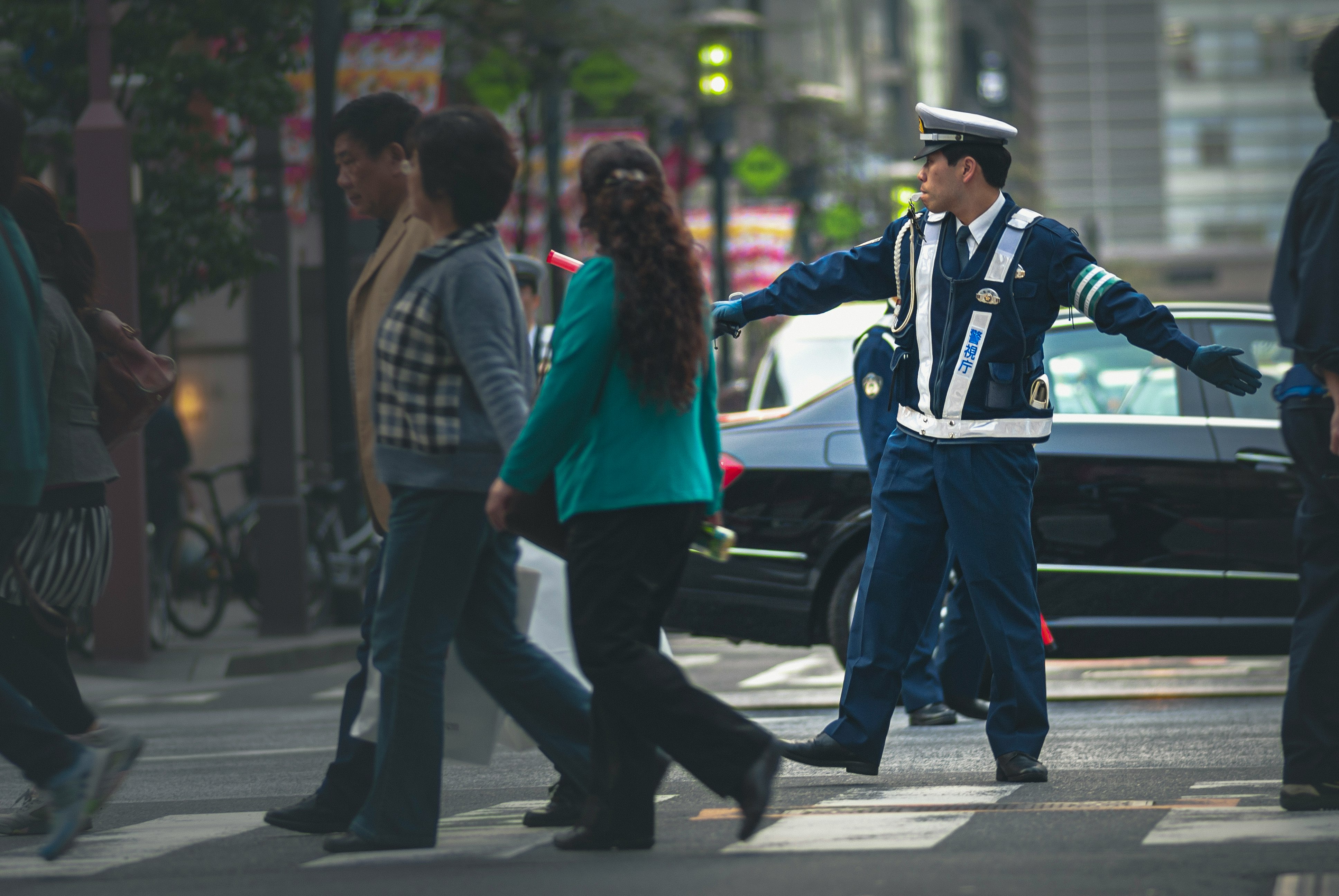 man in blue jacket and blue denim jeans standing beside woman in red jacket