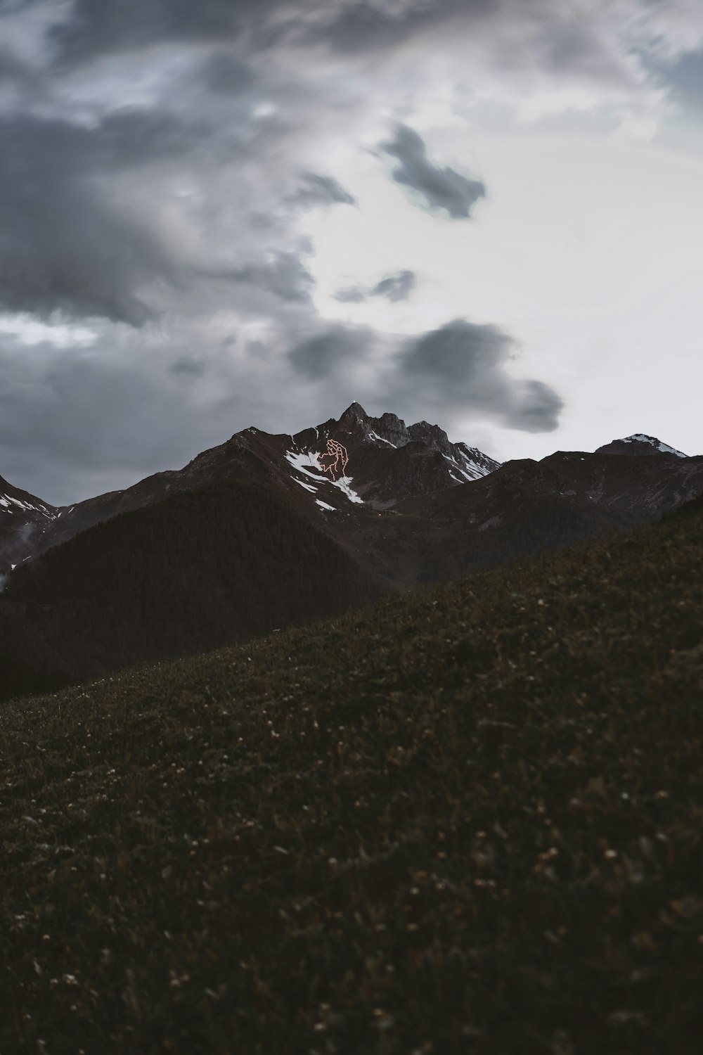 brown and black mountains under white clouds during daytime