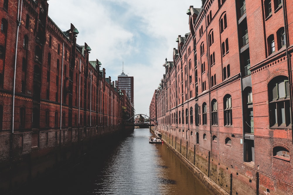 brown concrete building beside river during daytime