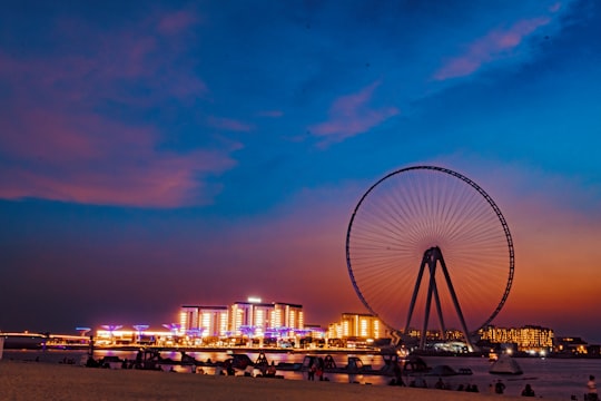 ferris wheel near city buildings during night time in Marina Beach - Dubai - Dubai - United Arab Emirates United Arab Emirates