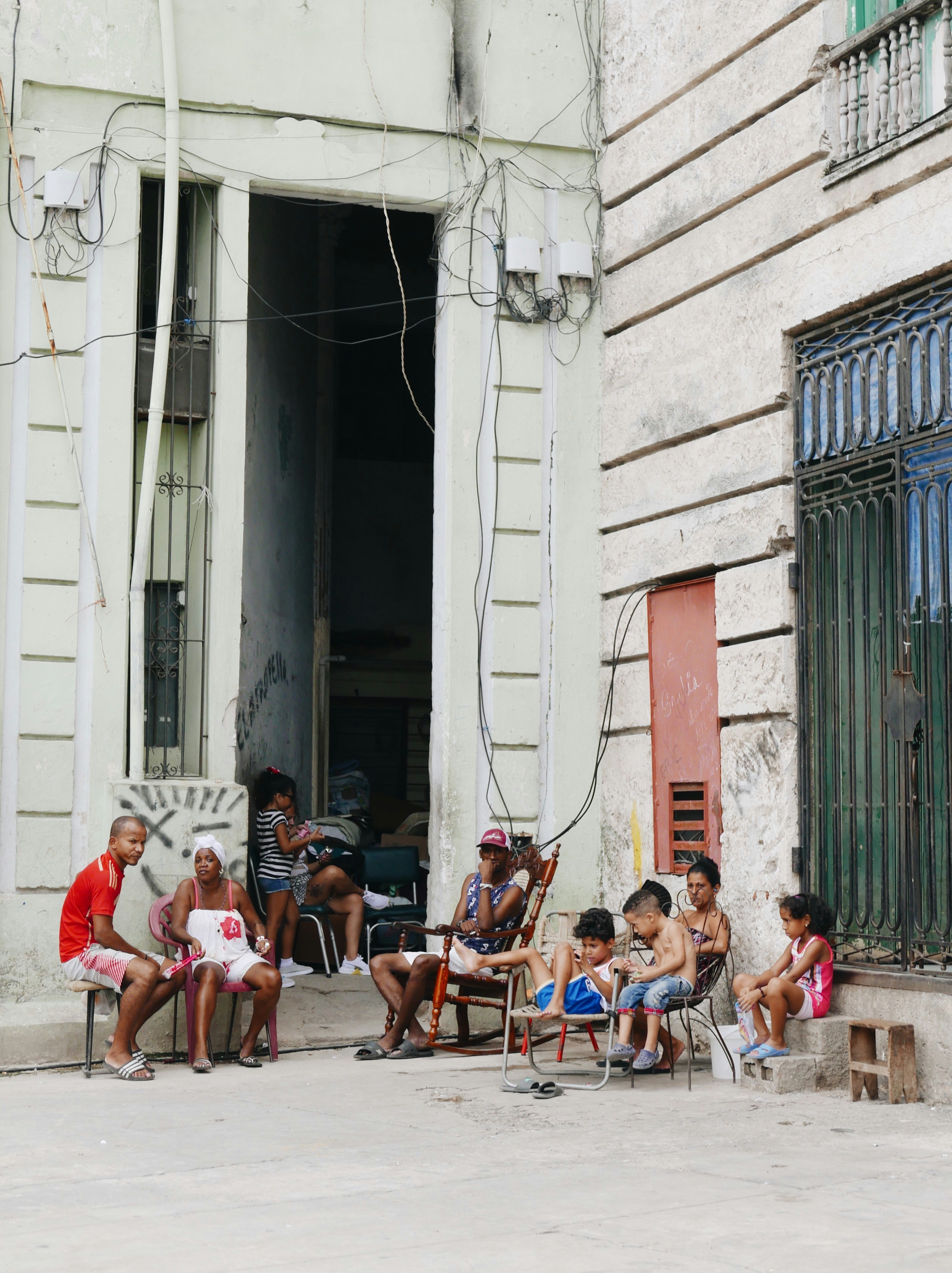 group of people sitting on brown wooden chairs