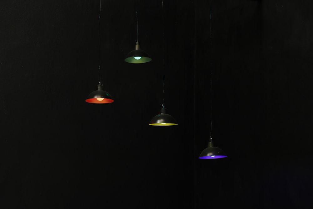 three red and gold pendant lamps
