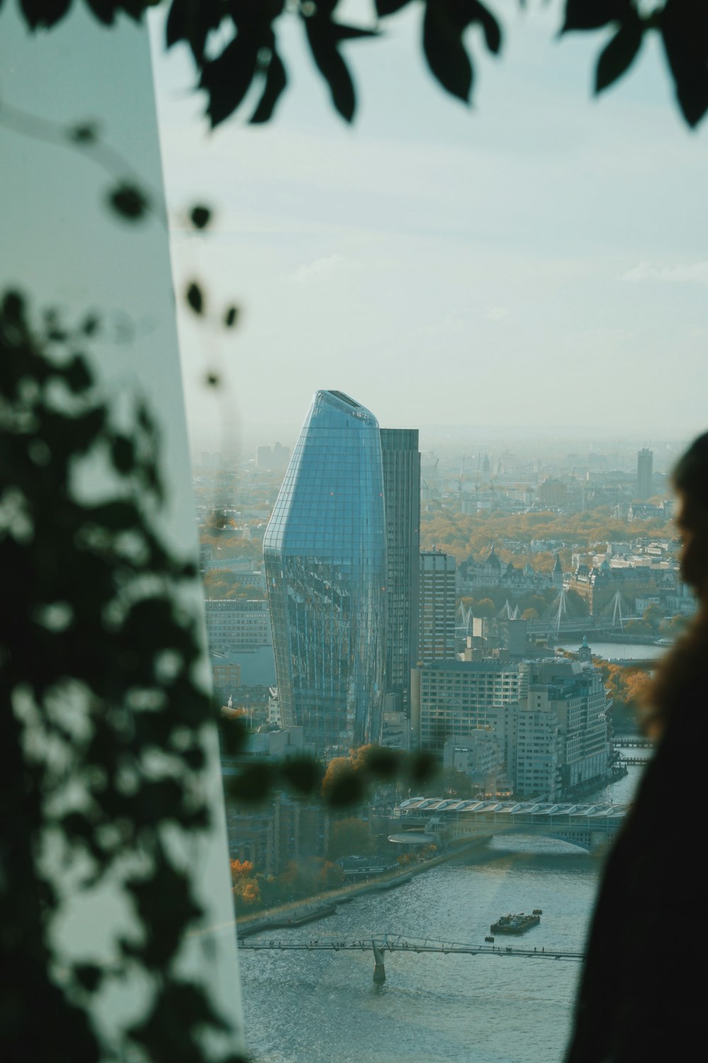 woman in black jacket standing near glass window