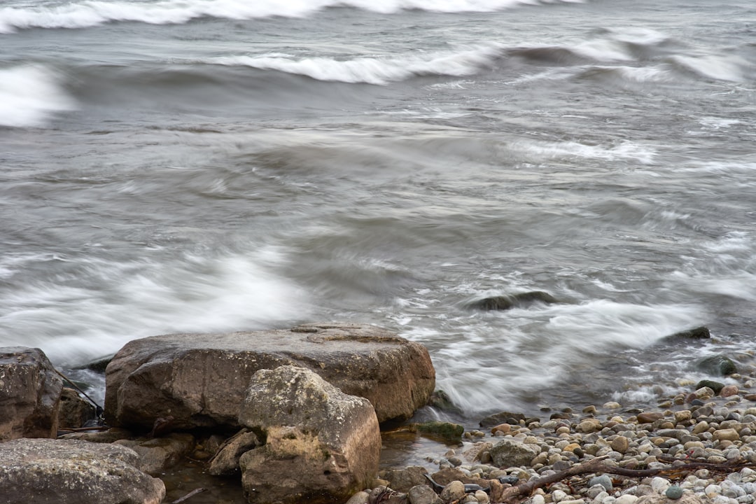 brown rocks near body of water during daytime