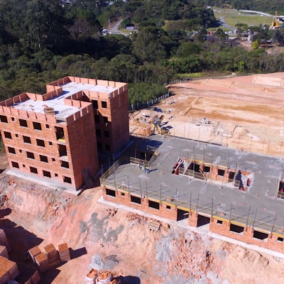 brown concrete building near green trees during daytime