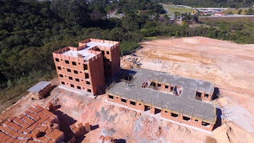 brown concrete building near green trees during daytime