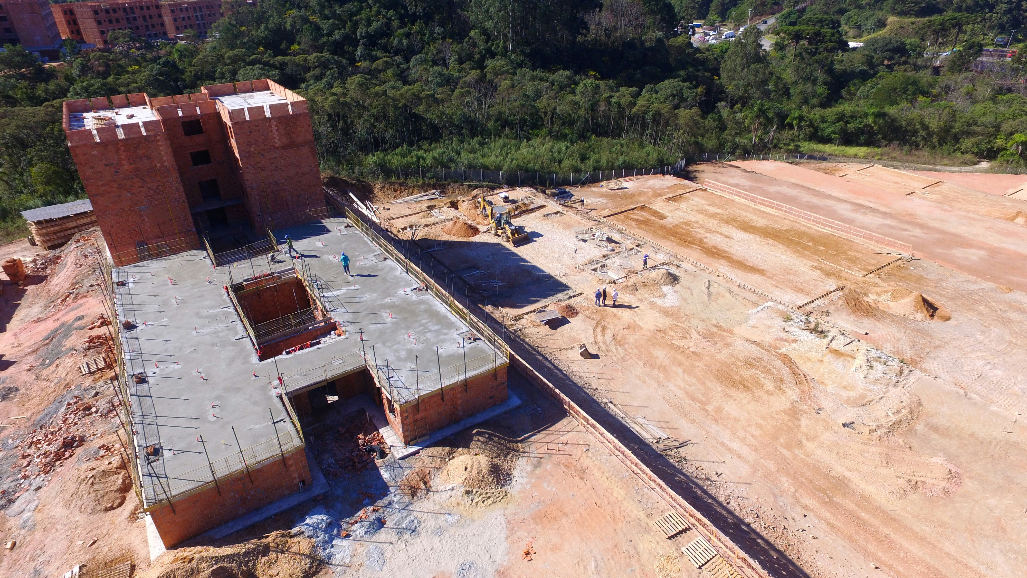 Civil construction site with workers and building infrastructure in outdoor setting