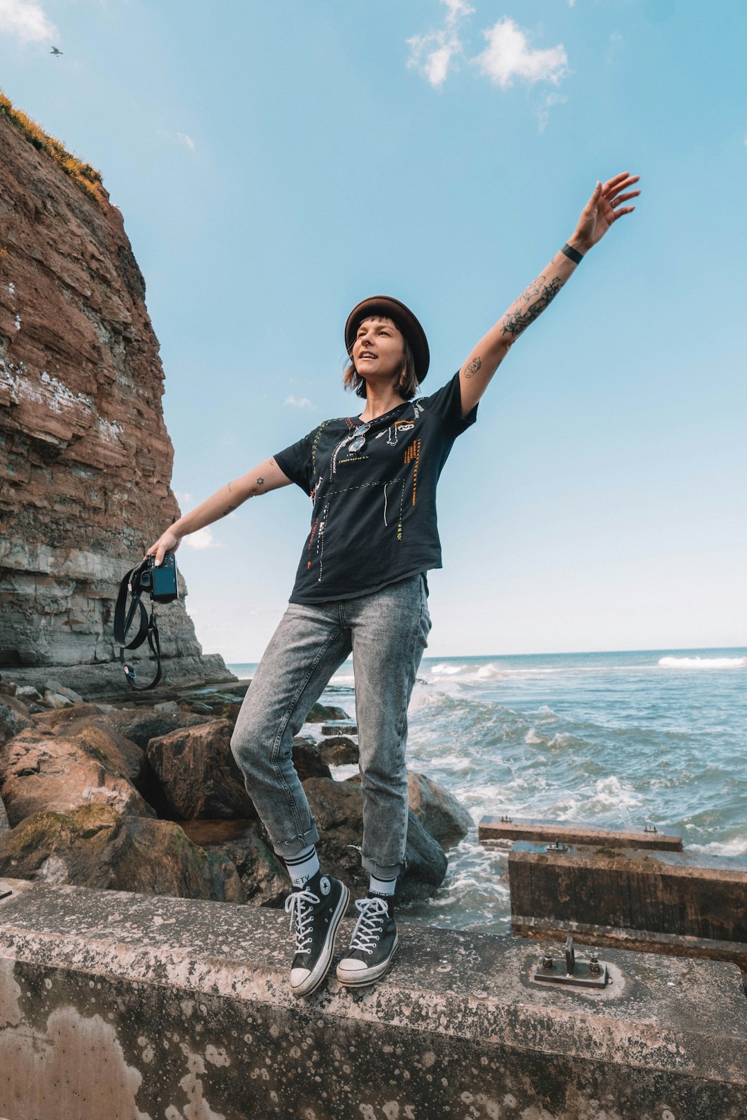 man in black crew neck t-shirt and blue denim jeans standing on brown rock near near near near near