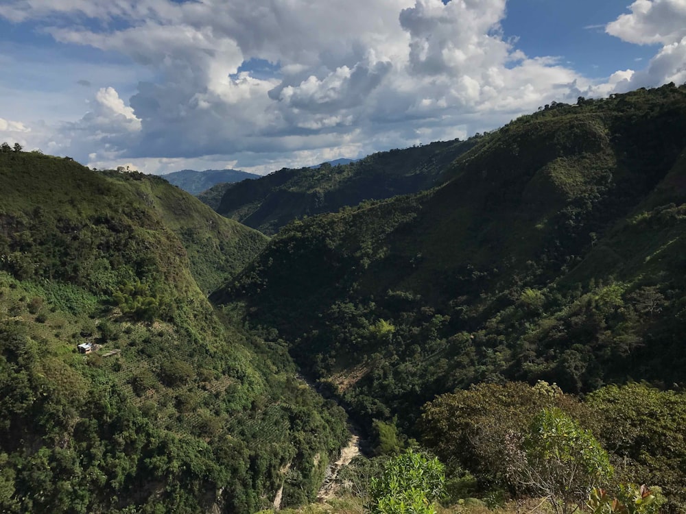 green mountains under white clouds during daytime