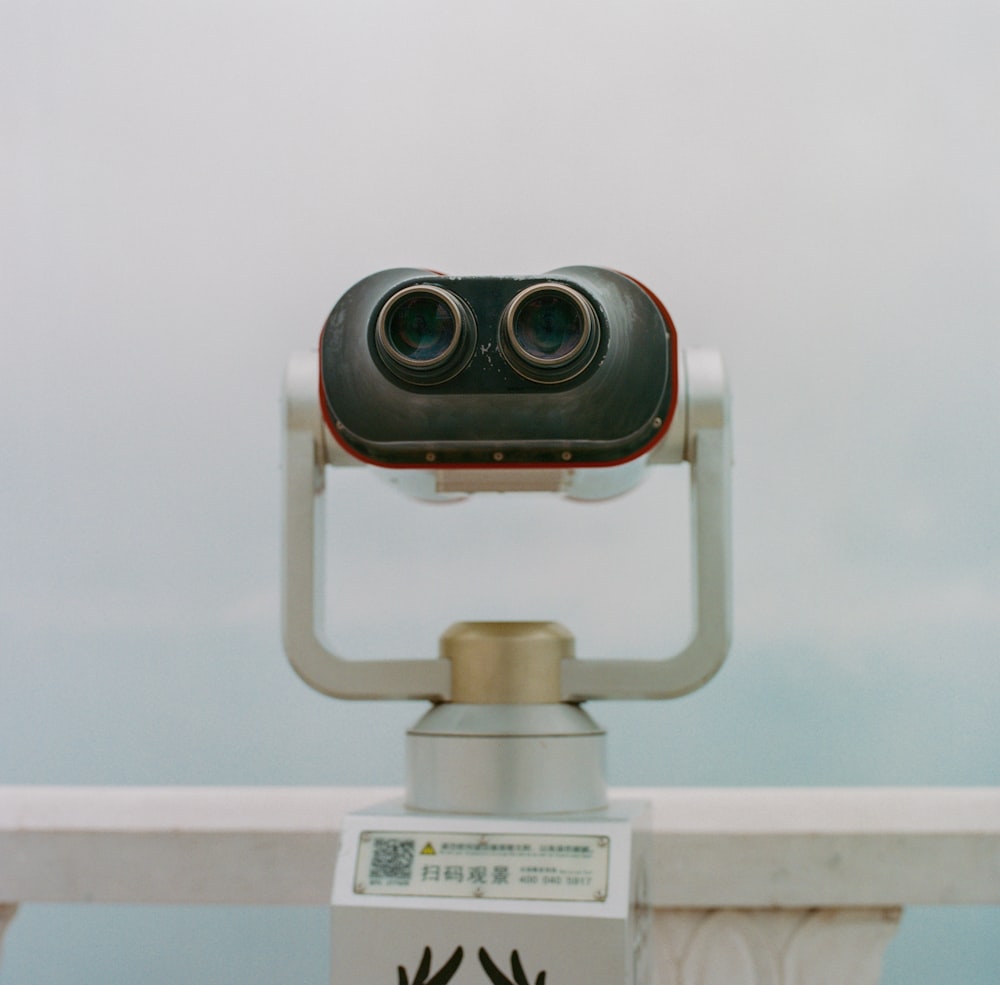 gray binoculars on white surface