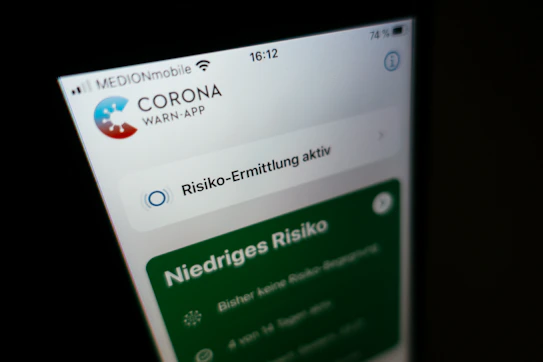 Close-up of a mobile device screen displaying security alerts and app protection status.