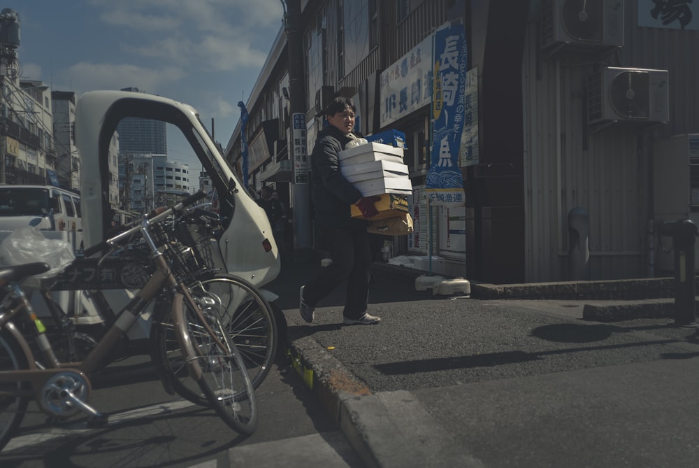 man in white shirt and black pants riding on black bicycle during daytime