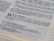 The image displays an open page of a Bible with a focus on a passage from Genesis 11, discussing the Tower of Babel. The text is clearly printed, highlighting themes of language and communication.