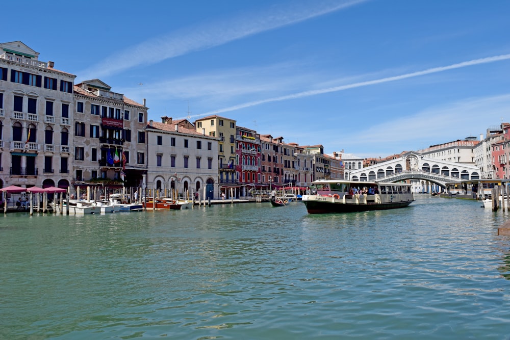 boat on water near buildings during daytime