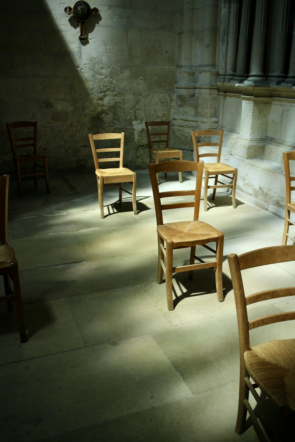 brown wooden chairs on gray floor tiles